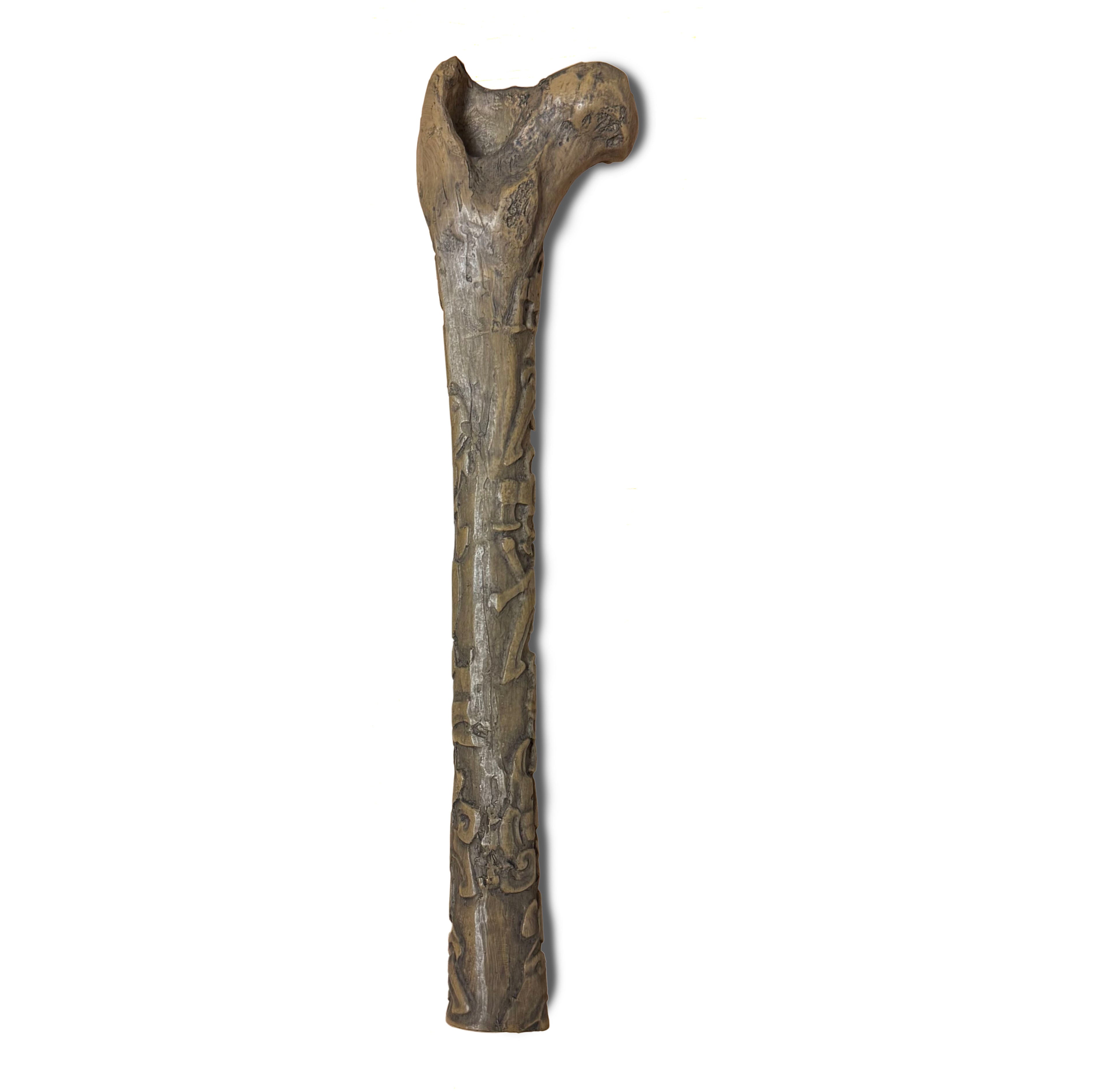 Reproduction of engraved Mayan artifact. A bone, most likely a monkey Femur. Relief engraving is a portrait of a ruler. Back of object.