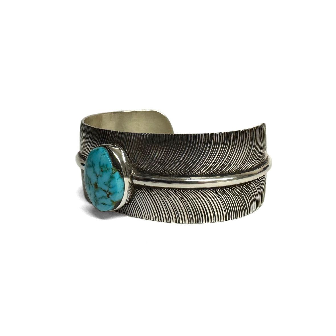 3/4 view of a silver bracelet with feather pattern and large turquoise stone at the center (facing left) on a white background.