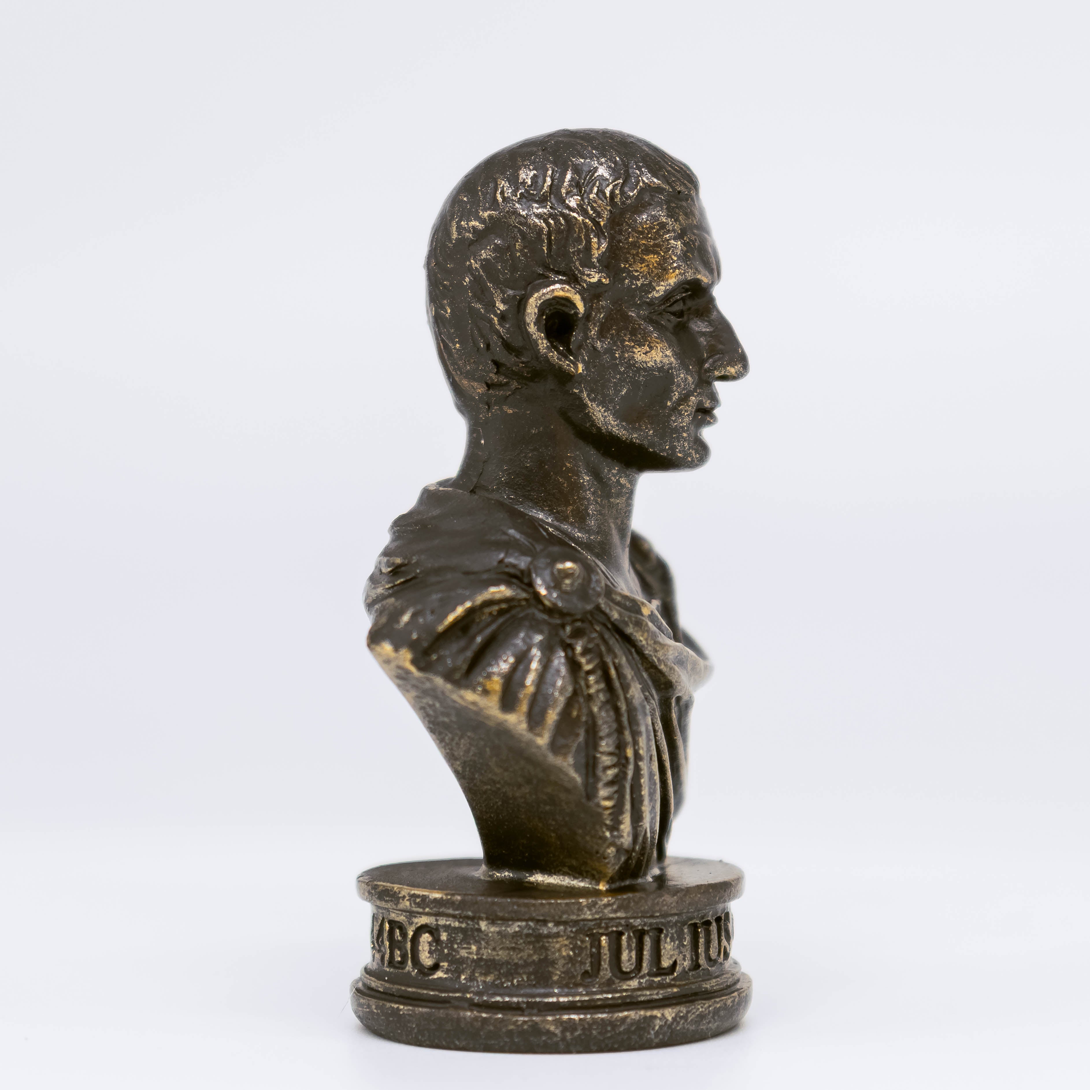 Side profile view of Caesar bust on white background. 