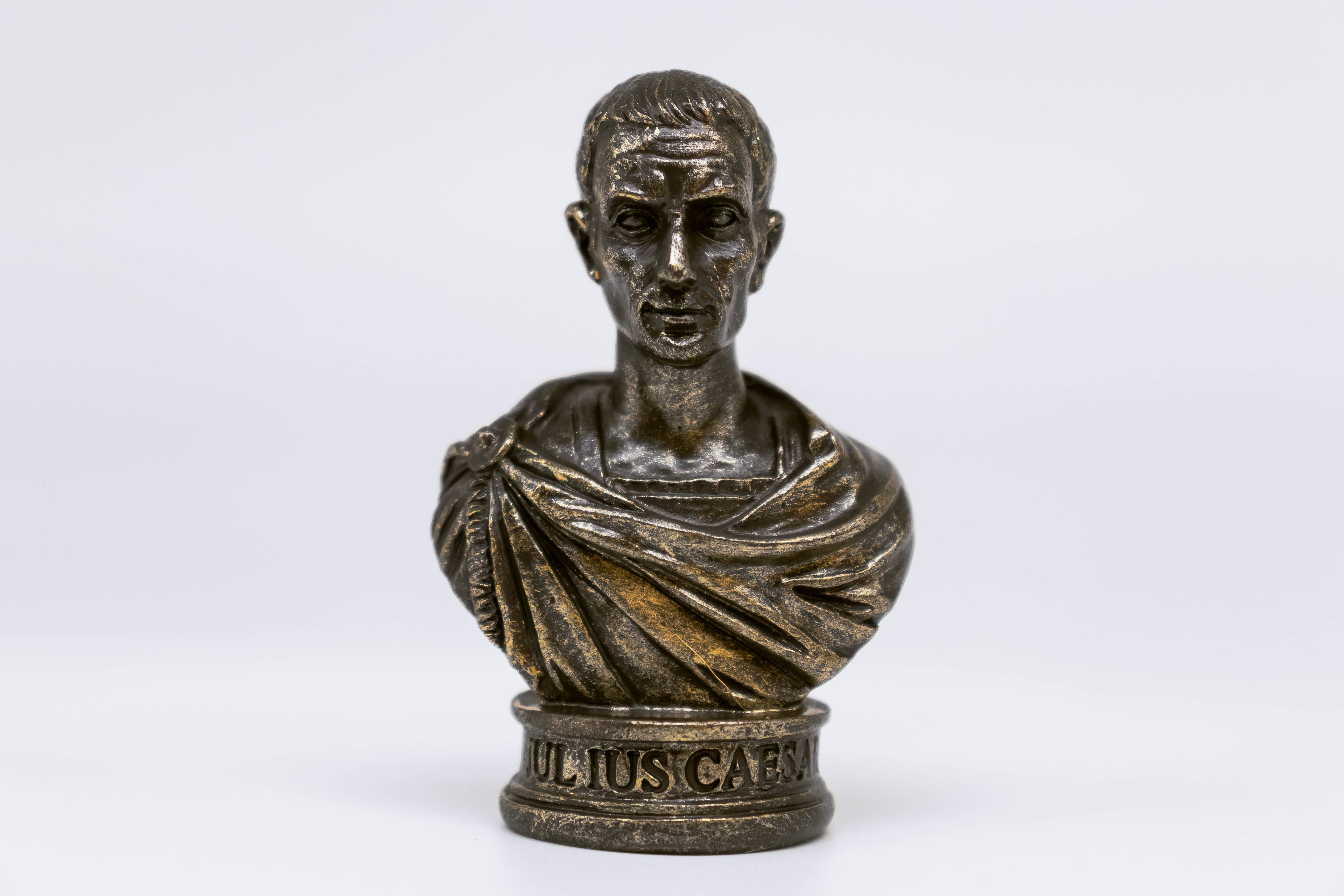 Straight-on front view of Caesar bust, inscription reads "Julius Caesar" on the bust which is fully visible, white background. 