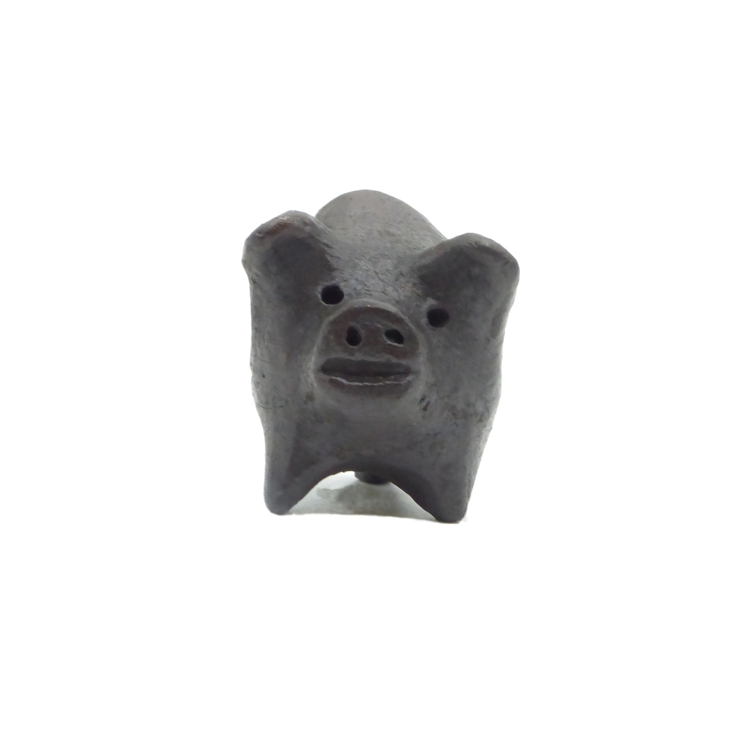 Small black piggy bank on a white background