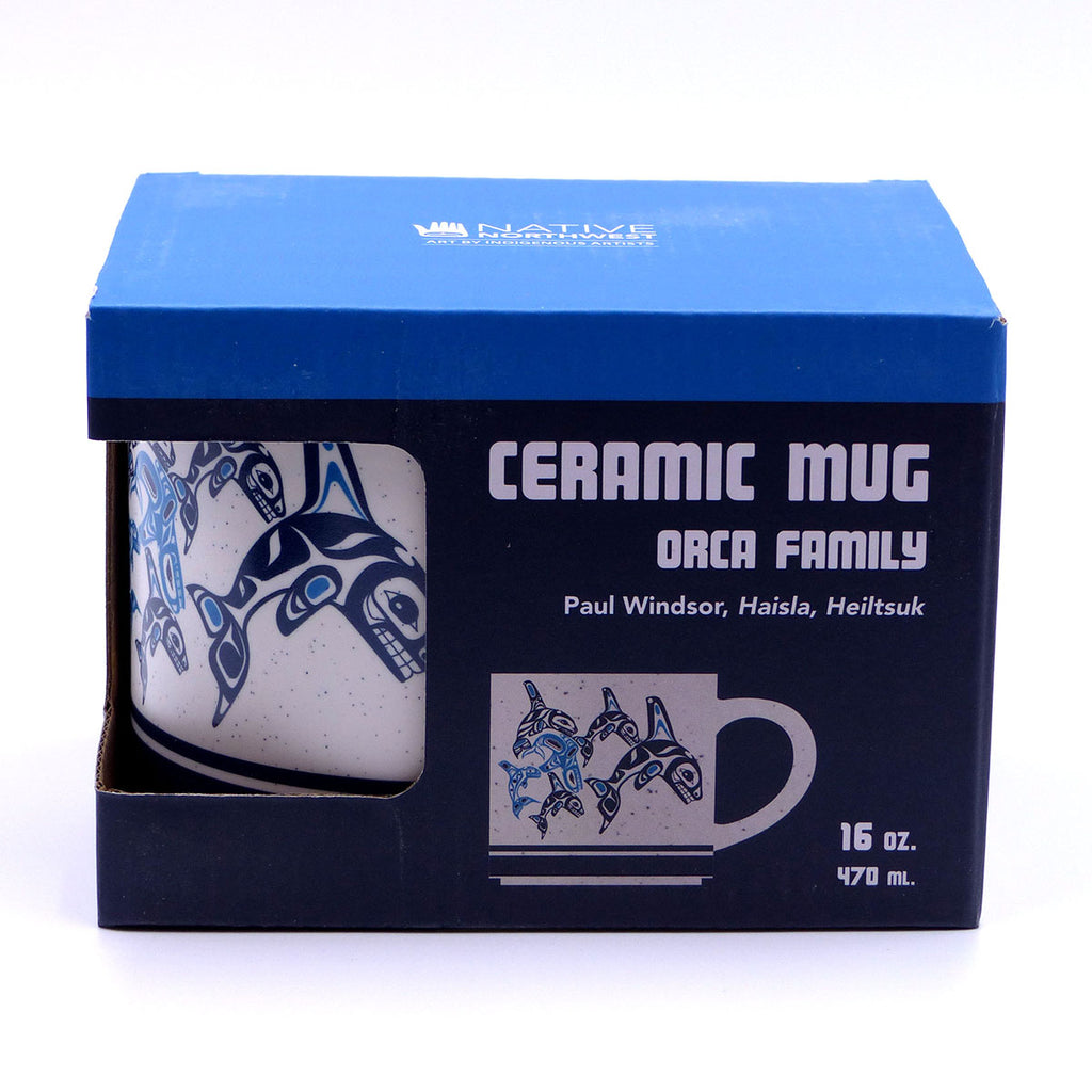 A ceramic mug with blue and white design featuring a graphic of orcas in its box which features a photo of the mug and product details.