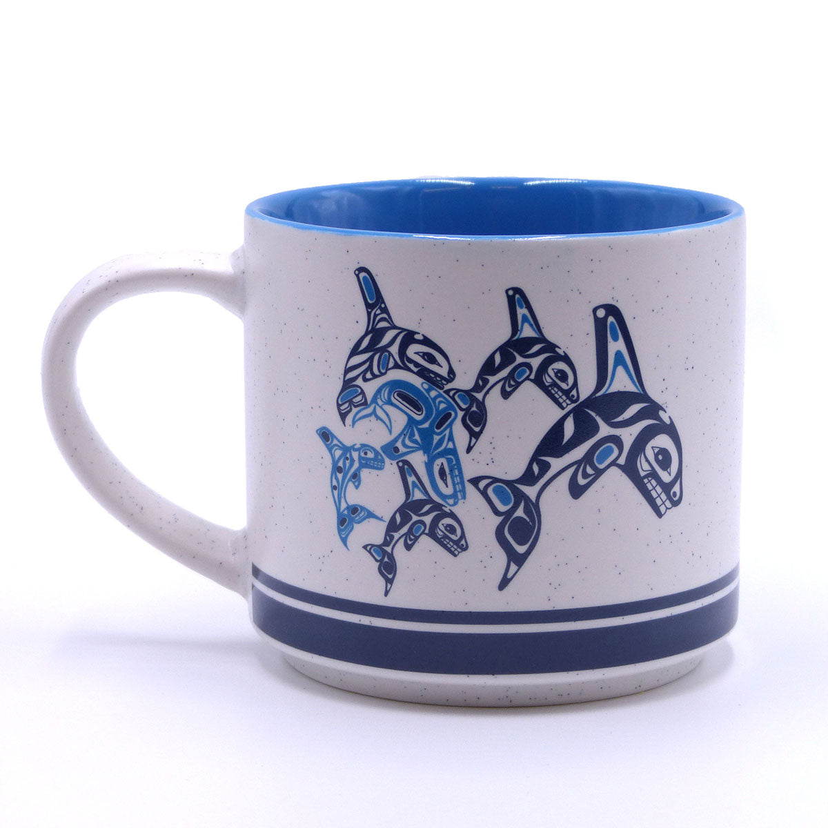 A ceramic mug with blue and white design featuring a graphic of orcas.