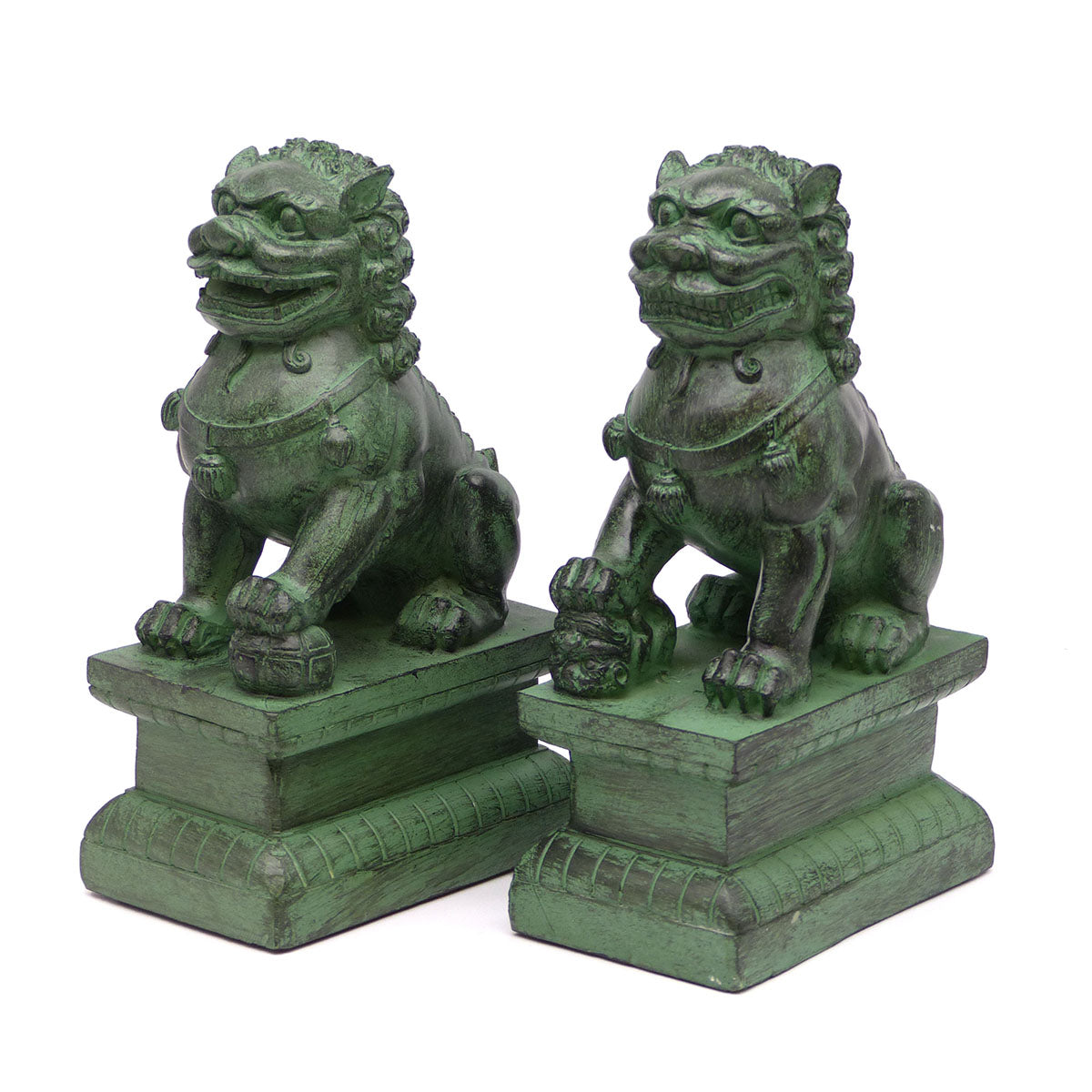 A pair of traditional Chinese Foo lions or Foo dogs, placed on bases, designed to resemble patinated bronze. Front 3/4 view facing left.